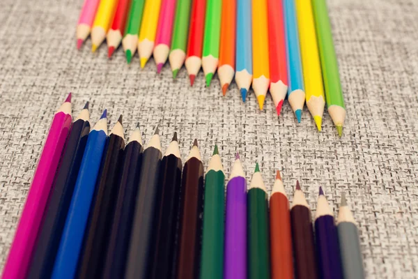 Colored pencils lined opposite each other — Stock Photo, Image