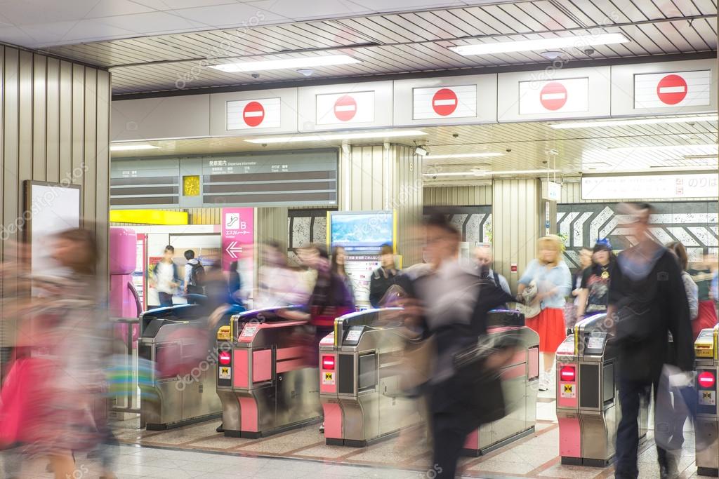 Blurred abstract background of many people at subway station in 