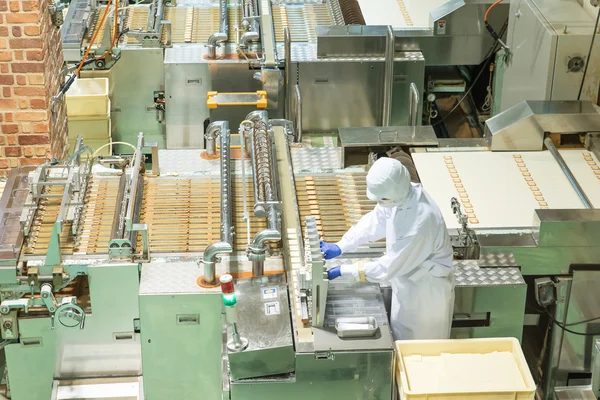 Worker working with machine in bakery factory — Stock Photo, Image