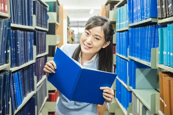 Female student  holding a notebook and smiling — Stock Photo, Image