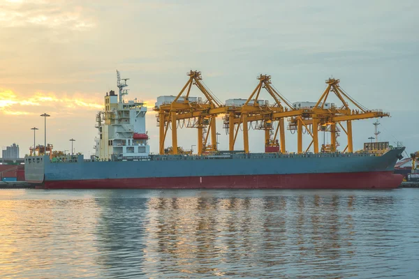 Port d'expédition avec grue pour le téléchargement de conteneurs au crépuscule — Photo