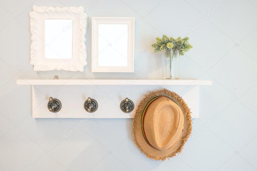 Hat hang on the  wall with picture frames