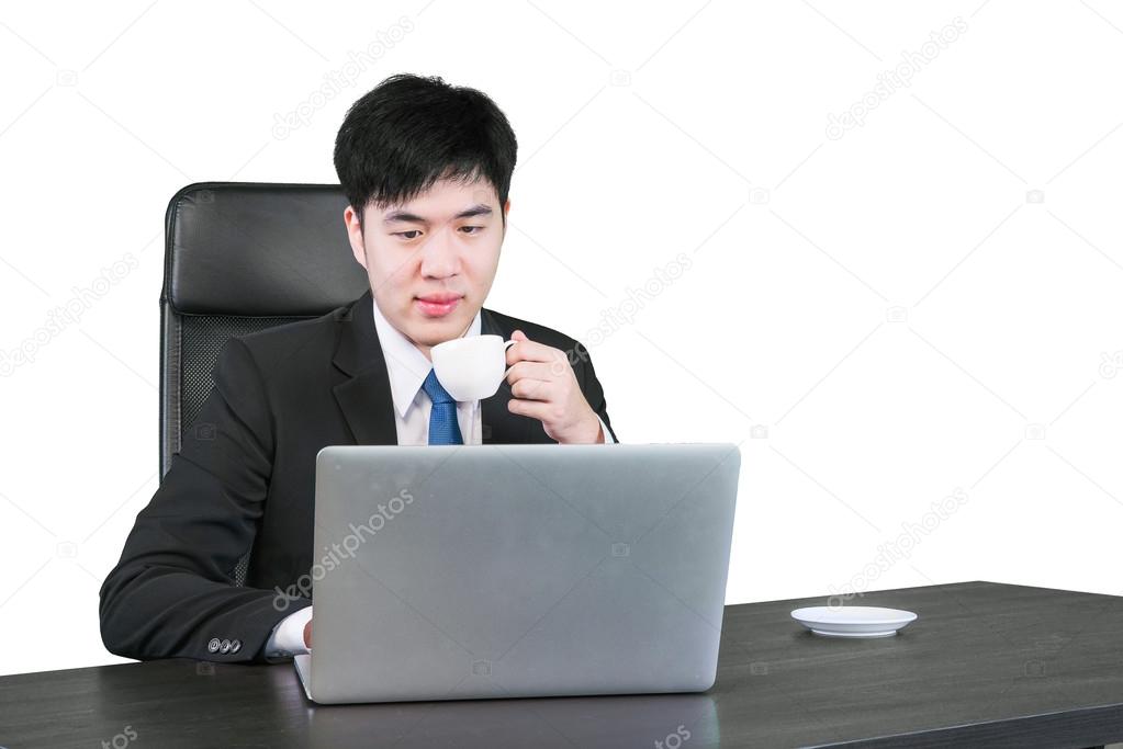 Asian businessman drinking coffee and working with computer 
