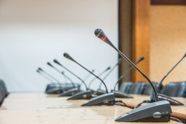 Mikrofonlar önünde boş sandalyeler.