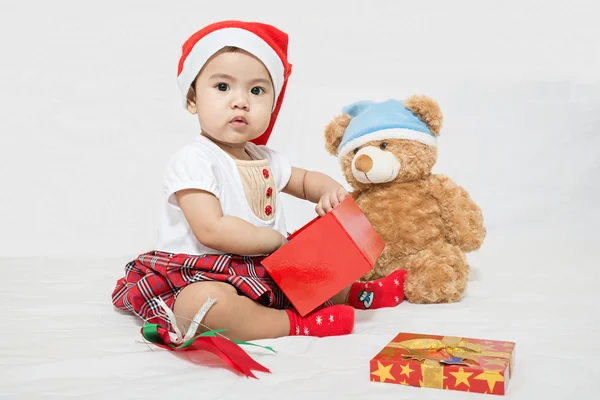 Asian baby with christmas cap pick up something in gift box — Stock Photo, Image