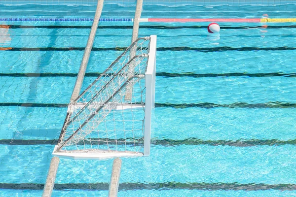 Water polo goal and ball in swimming pool — Stock Photo, Image