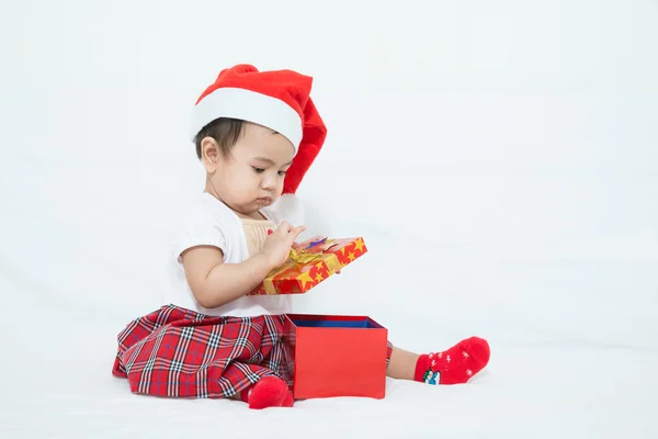 Asian baby with christmas cap opening gift box — Stock Photo, Image