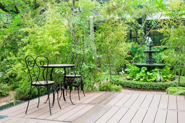 Black chair in the garden for ralex — Stock Image Black chair in the garden for ralex Stock Photo