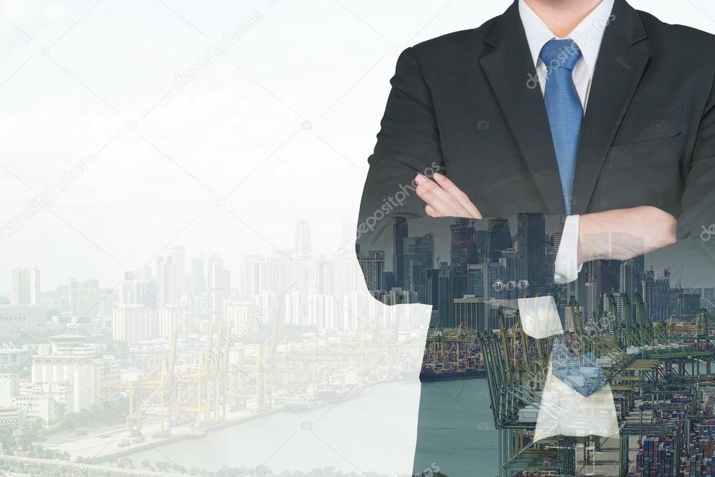 Double exposure of businessman and shipping port