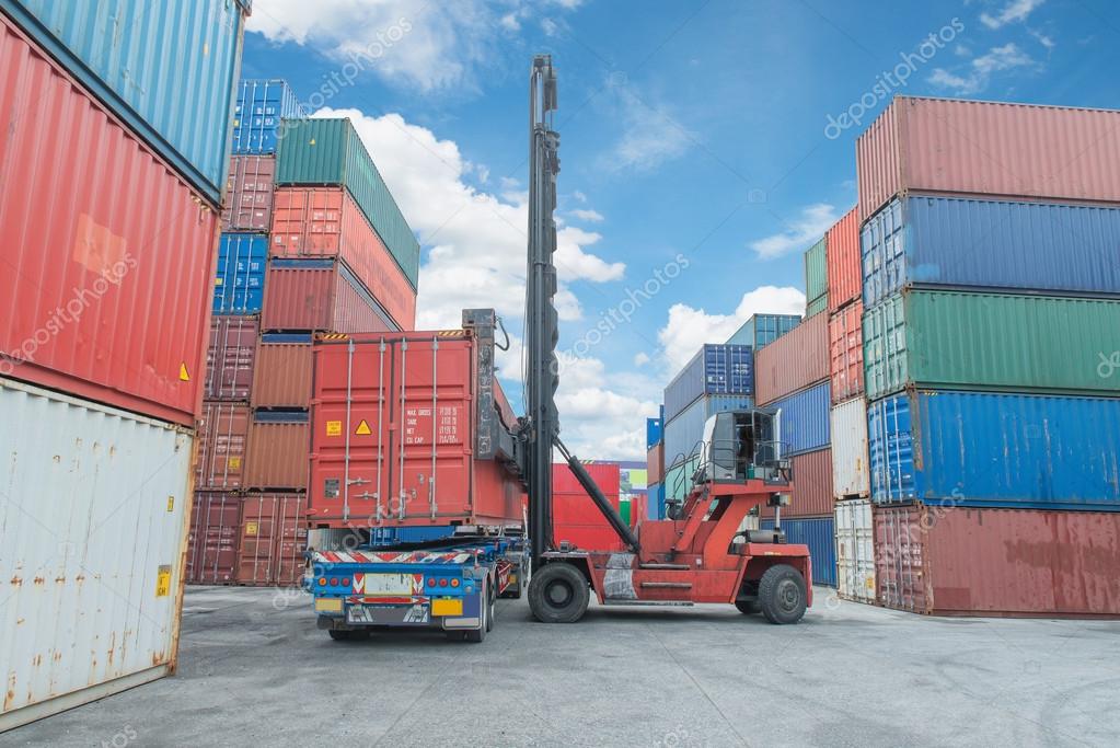 Crane lifter handling container box loading to truck Stock Photo by