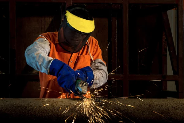 Industrial worker cutting and welding metal with many sharp spar — Stock Photo, Image