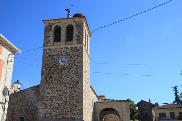 nest of storks in the bell tower of the church of a town in Madrid