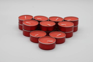 Kırmızı aromalı mumlar. Kırmızı arkaplanda izole edilmiş üçgen. Romaterapi..