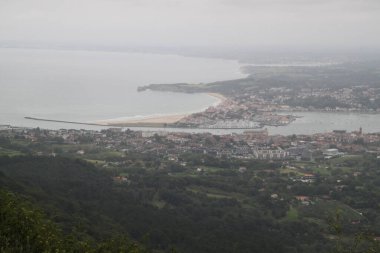 Hendaye beach in France seen from Mount Jaizkibel in the Basque Country on a cloudy summer day