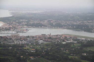 View of the Bidasoa estuary in the bay of Txingudi on a cloudy day seen from Mount Jaizkibel in the Basque Country