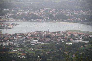 View of the Bidasoa estuary in the bay of Txingudi on a cloudy day seen from Mount Jaizkibel in the Basque Country