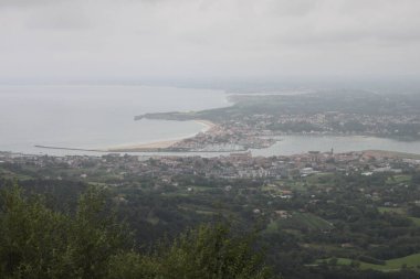 Hendaye beach in France seen from Mount Jaizkibel in the Basque Country on a cloudy summer day