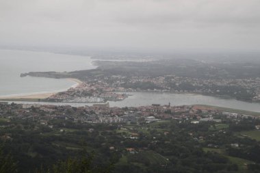 Hendaye beach in France seen from Mount Jaizkibel in the Basque Country on a cloudy summer day