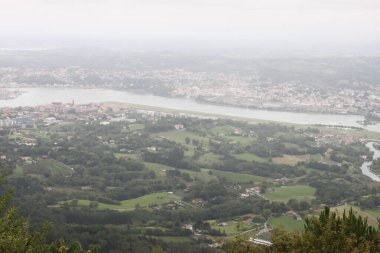 View of the Bidasoa estuary in the bay of Txingudi on a cloudy day seen from Mount Jaizkibel in the Basque Country