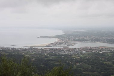Hendaye beach in France seen from Mount Jaizkibel in the Basque Country on a cloudy summer day