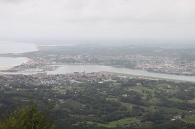 Hendaye beach in France seen from Mount Jaizkibel in the Basque Country on a cloudy summer day