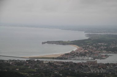 Hendaye beach in France seen from Mount Jaizkibel in the Basque Country on a cloudy summer day