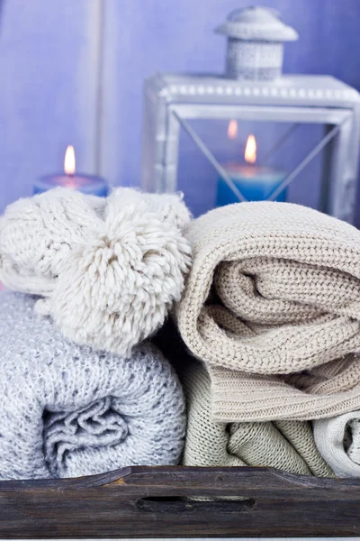 Warm scarfs with candles, selective focus — Stock Photo, Image