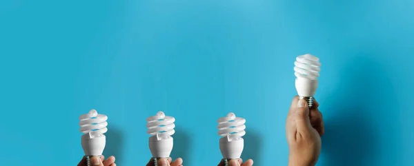 light bulb idea energy hand holding light bulb on blue background Innovative idea Concept  innovation and inspiration