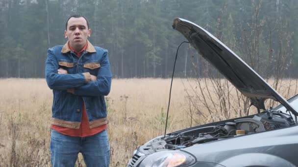 Joven estresado hombre teniendo problemas con su coche roto — Vídeos de Stock