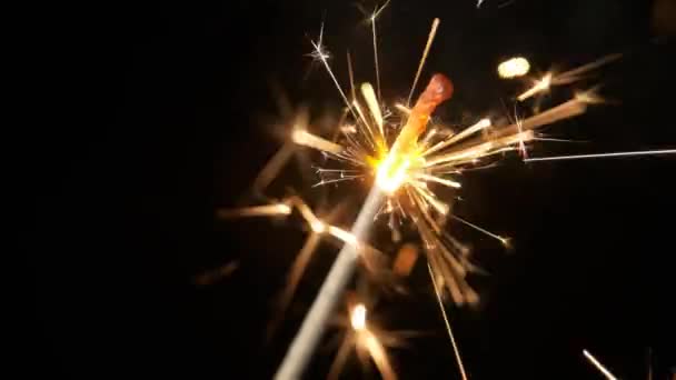 Slow motion of burning sparklers on black background. — Stock Video