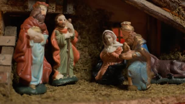 Woman puts miniature figurines. Beautiful nativity scene and christmas decorations - close view — Stock Video