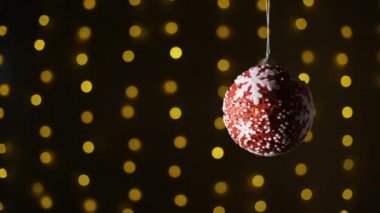 Beyaz yıldızlı kırmızı noel balesi. Arka planda çelenk var. Uzayı kopyala Bokeh. Yıldız soyut dekorasyon ışıkları, çok renkli, parlak bulanık arkaplan.