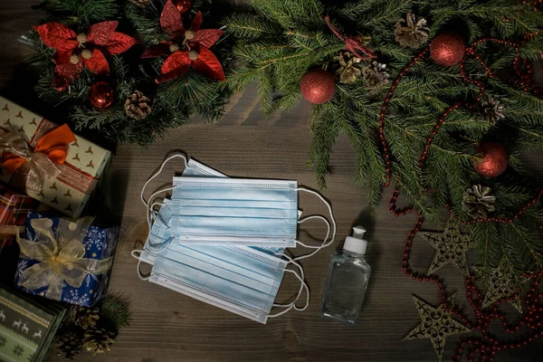Maske ve ahşap masa üzerinde dezenfektan ile Noel süsü. Yüksek kalite fotoğraf