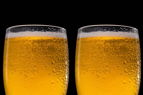 Glasses of beer on black background. Close up