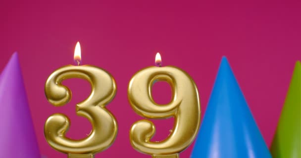 Vela de pastel de cumpleaños ardiente número 39. Feliz cumpleaños aniversario de fondo concepto de celebración. Sombrero de cumpleaños en el fondo — Vídeo de stock