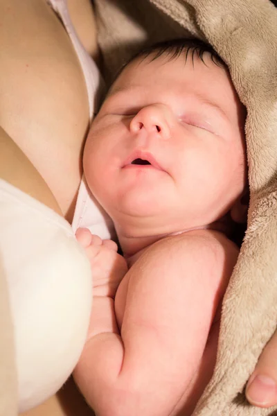 Baby sleeping on the breast of mother Royalty Free Stock Photos