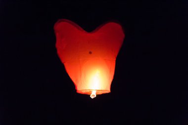 Flying lantern in the dark sky clipart