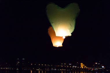 Flying lantern in the dark sky clipart