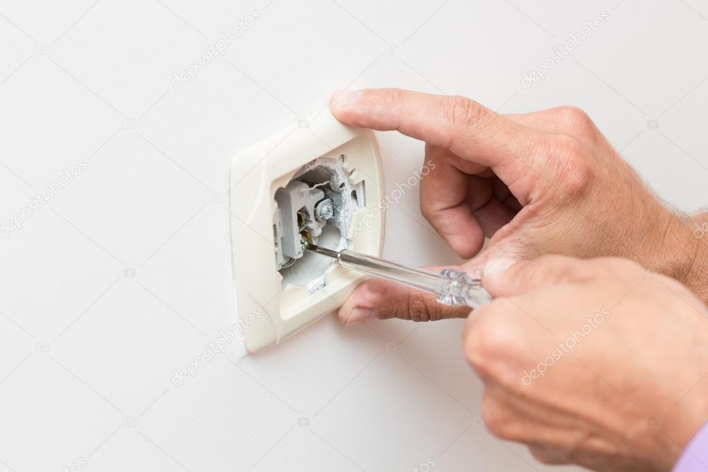 Electrician repairing socket