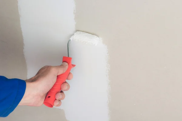 Man using paint roller on the wall — Stock Photo, Image