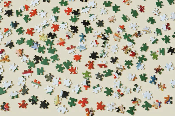 Colorful puzzle pieces on clear background.