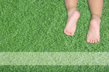 baby's feet on artificial turf 