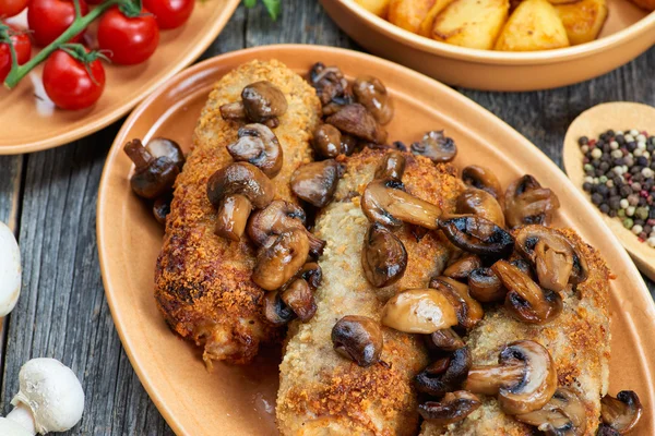 Roulade van varkensvlees met geroosterde paddenstoelen en aardappelen — Stockfoto