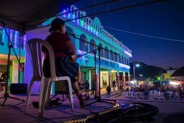 woman sitting counting building in background