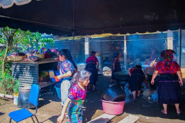 Maya yerlileri Cajola 'da tipik dumanlı kıyafetlerle yemek pişiriyor.