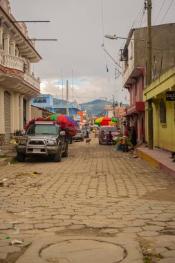 car parked on the street with vendors