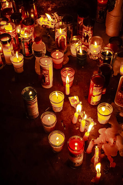 colored candles lit on the ground