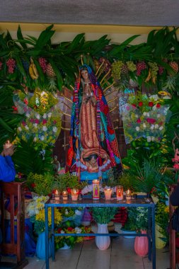 Çiçekler ve mumlarla Guadalupe 'nin güzel bakiresi