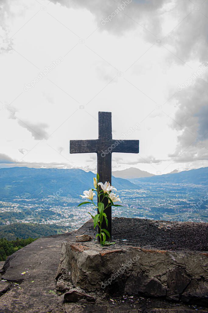 cross of sacred Mayan alatar of black color on altar with background of mountains