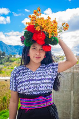 Mayan indigenous woman with flowers on her head with cloud background clipart